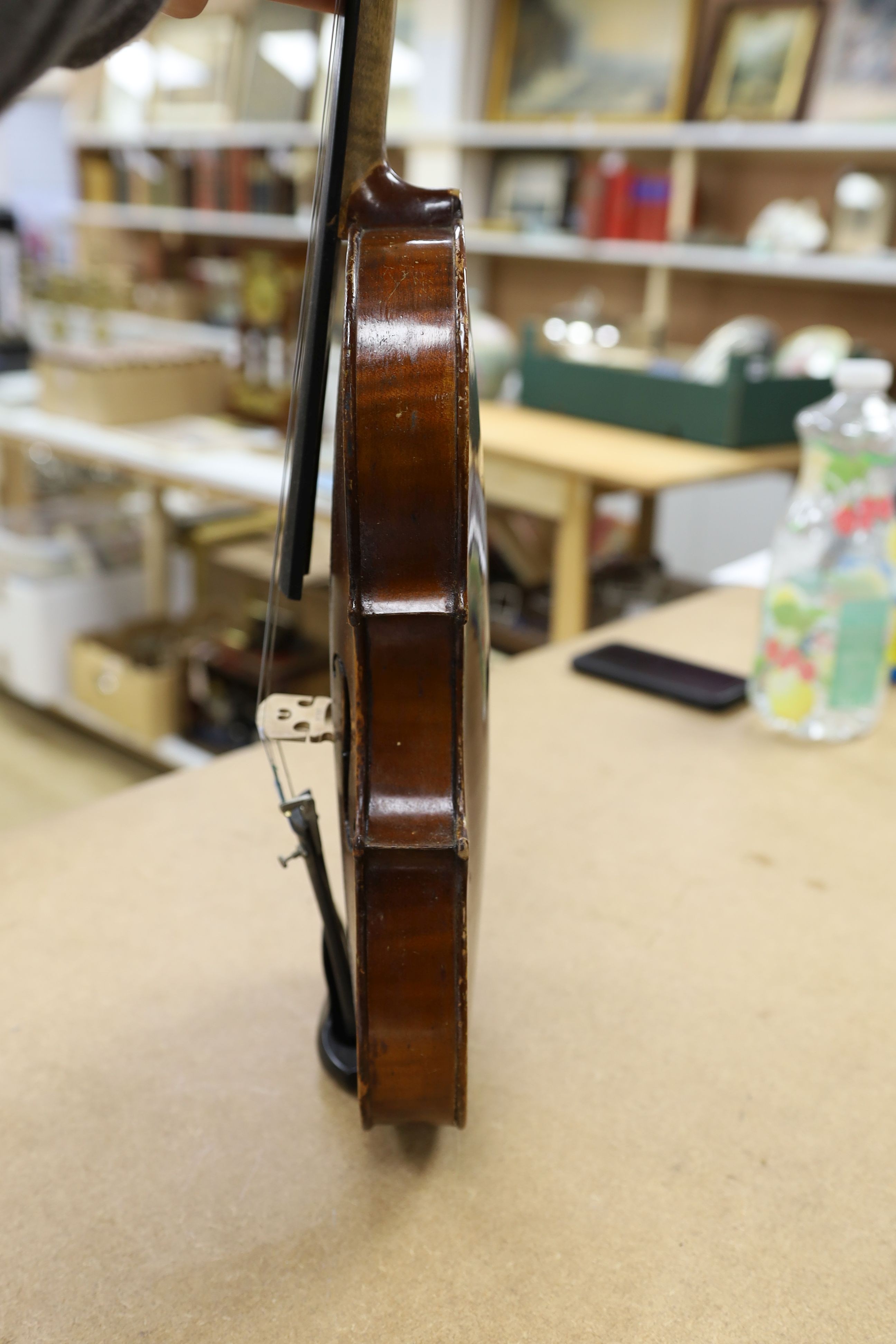 A cased violin, back 36cm, with bow